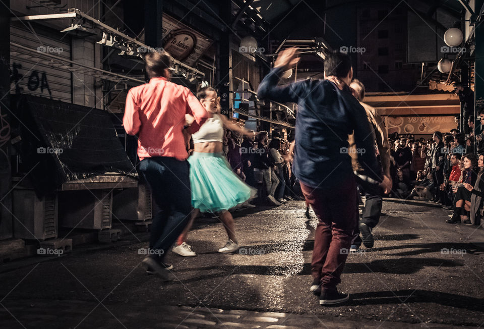 Street Dancing In The Night With Crowd Of People Watching
