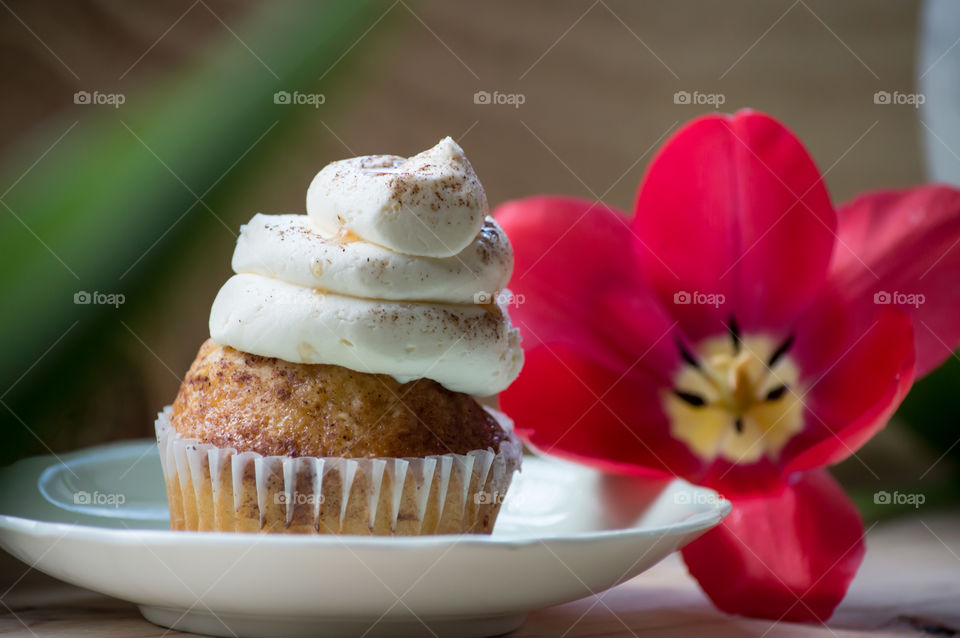 Fresh spiced vanilla cupcake on saucer