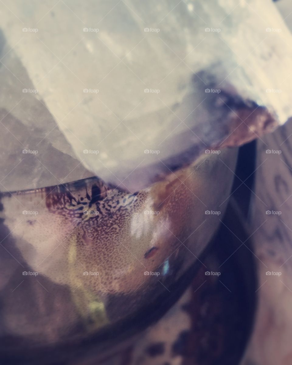 Crystal in a jar. The jar was something I used to muffle incent smoke and it has a nice little pattern. Next to it is a bone carving.