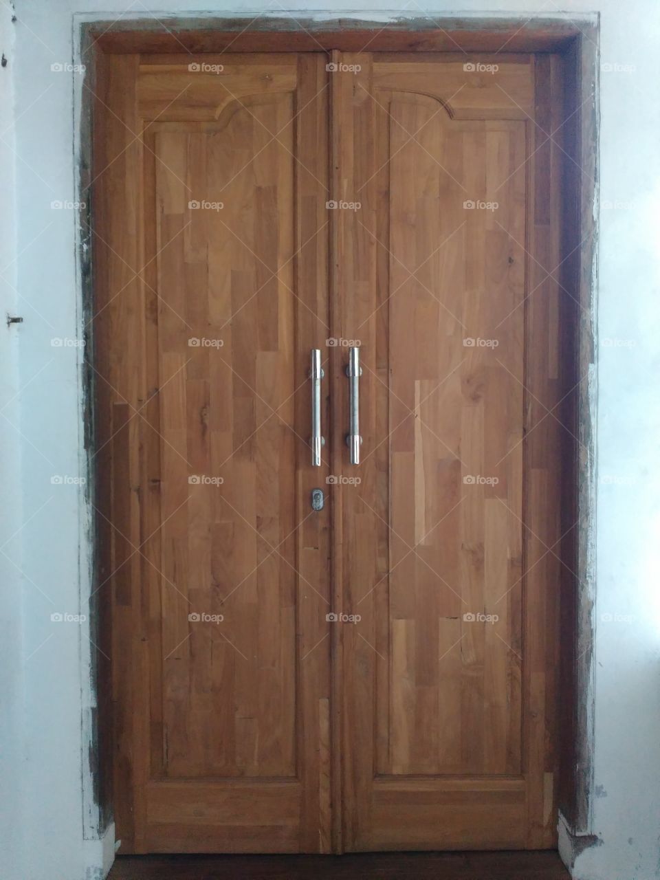 this door is made by using small parts of the woods which pressing.