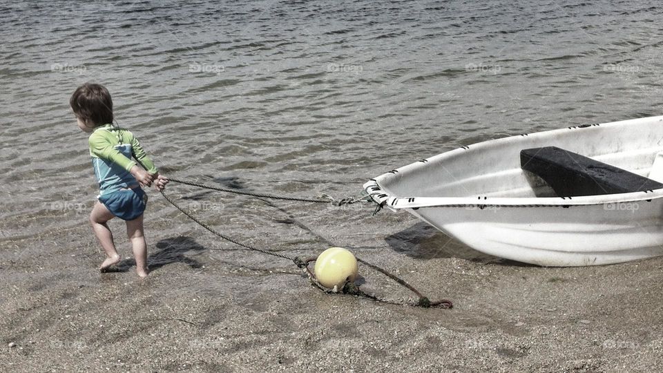 Child pulling a small boat