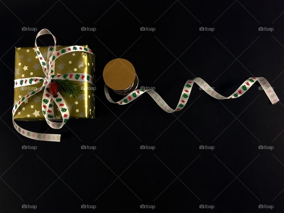 Christmas gift and ribbon on black background