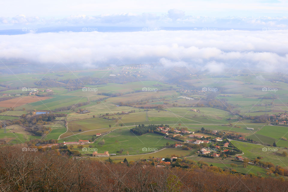 Top view to the foggy valley with villages