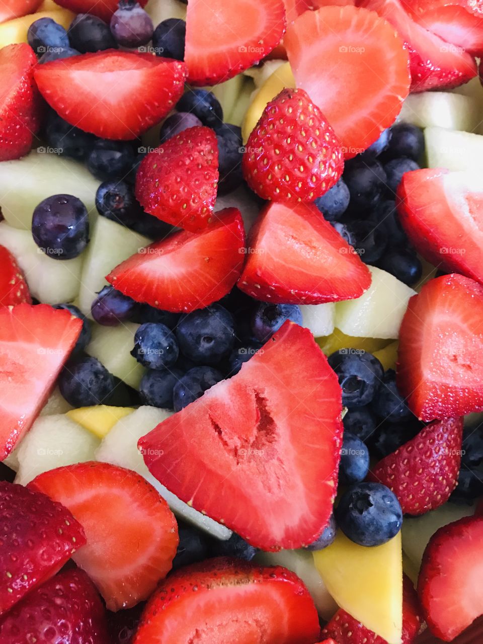 A fresh bowl of fruit salad in close up, healthy snacks for the family gathering. 