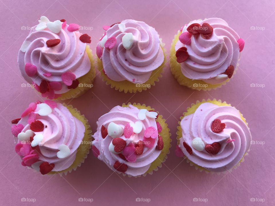 Looking down on a total of six pink cupcakes!