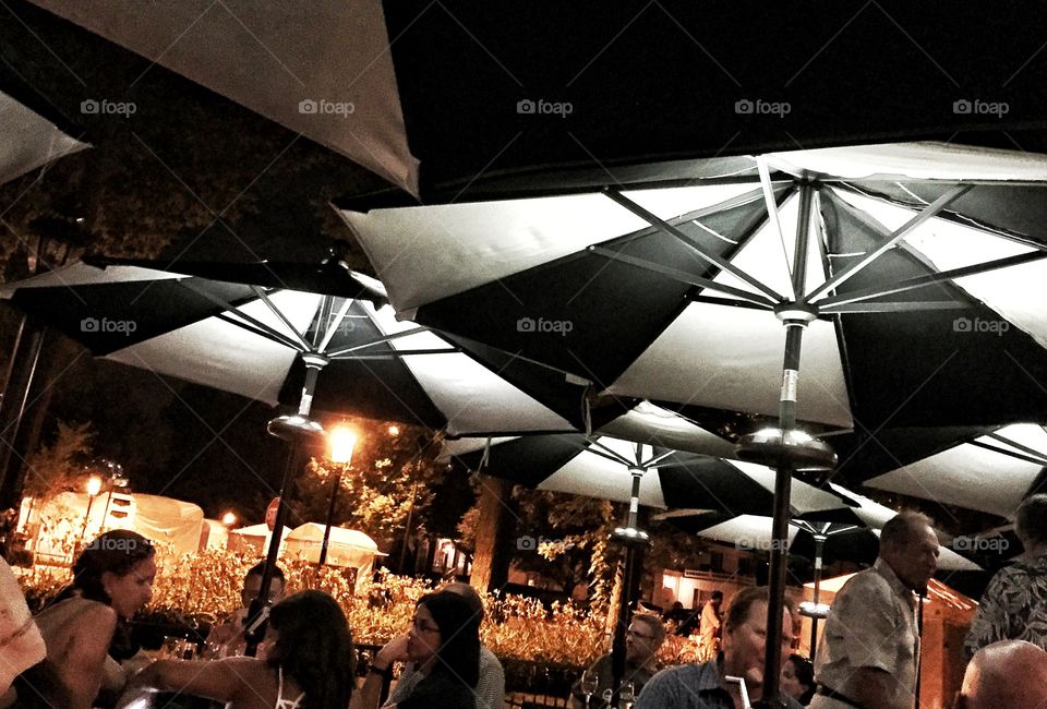 Umbrellas at night. Black and white patio umbrellas at an outdoor summer event