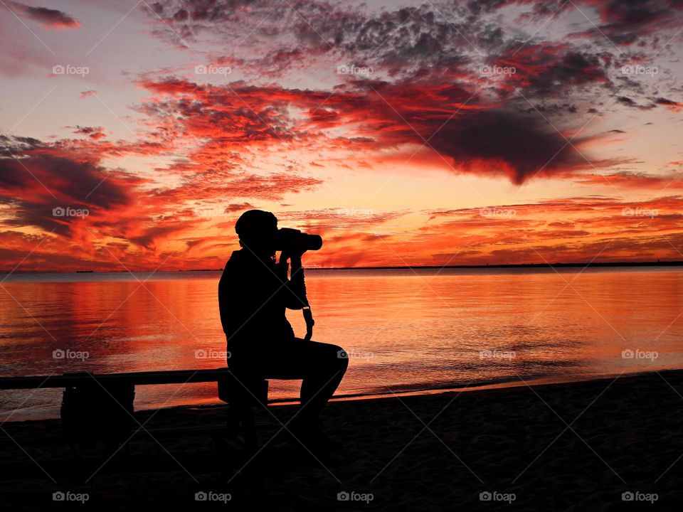 Sunset over the bay. Sunsets, with their panoply of blues, bouquets of yellows, bushels of oranges, and engulfment of reds, will move through a specified choreography as the earth passes from day to night. This is life at its finest.