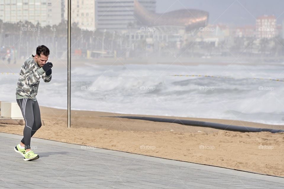 Practicing Boxing by the sea in a cold and grey day