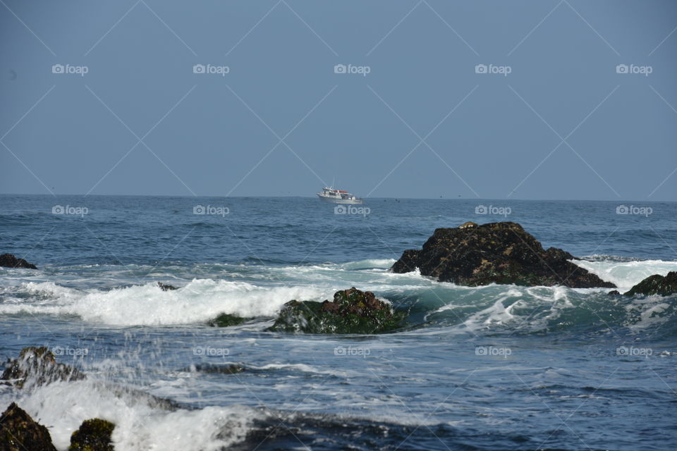 Seafaring boat in the horizon