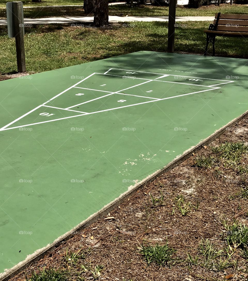 Another green shuffleboard court