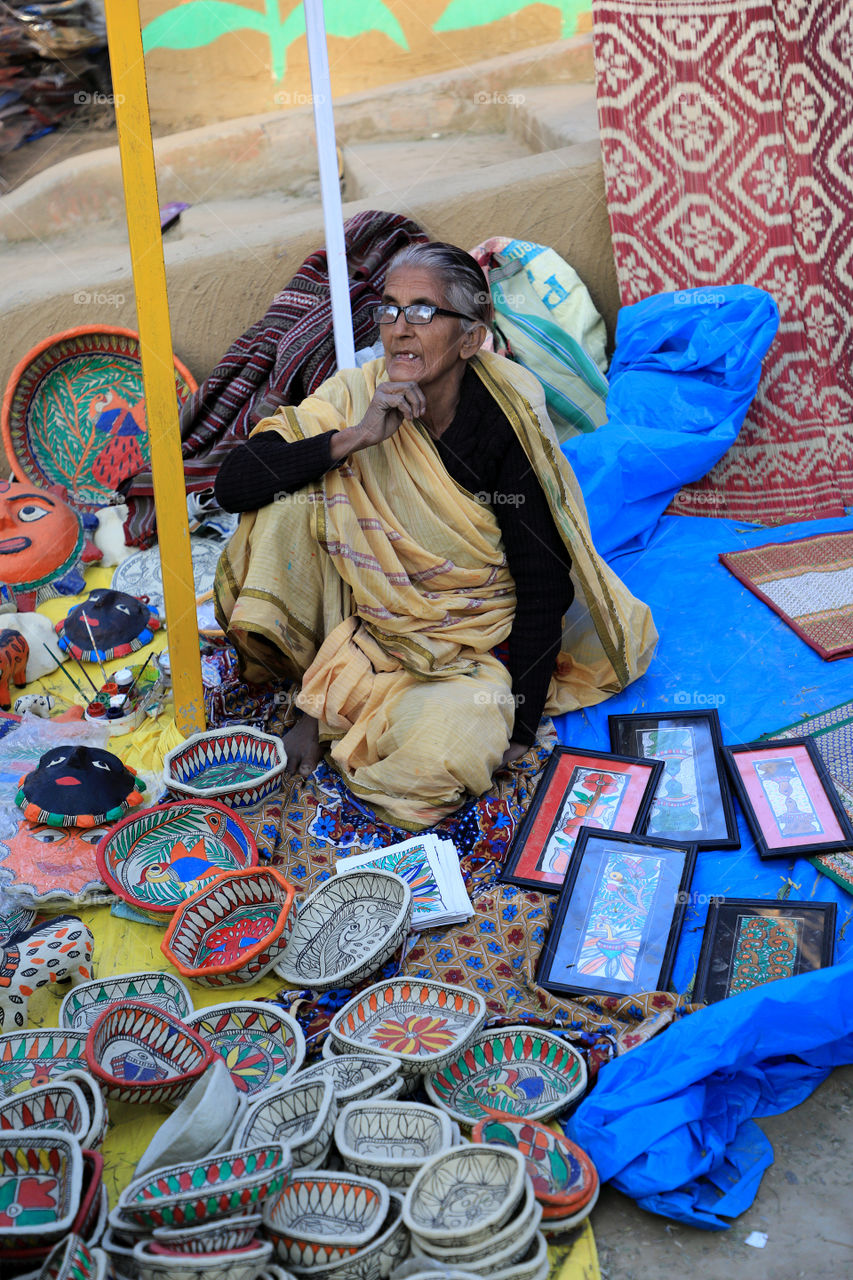 Am old Indian lady selling traditional stuff