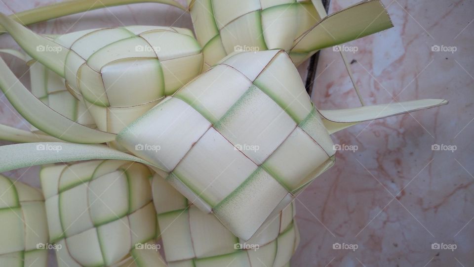 Making ketupat on the terrace of the house