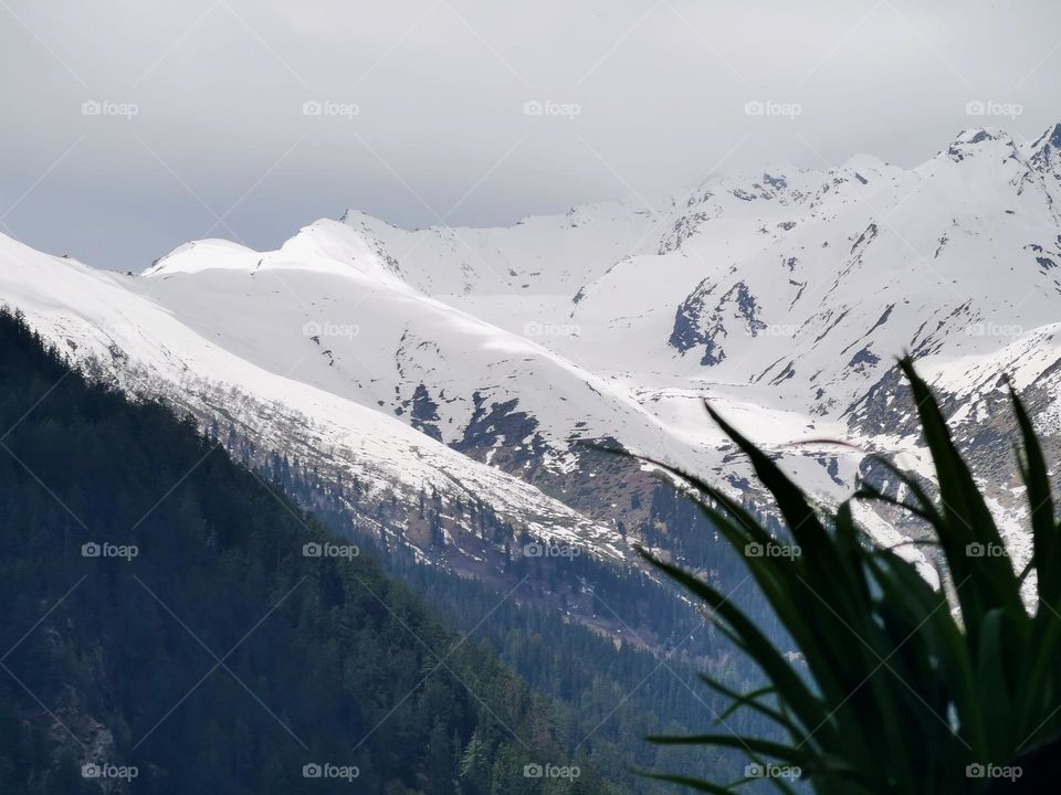 Shades of clouds on mountain snow