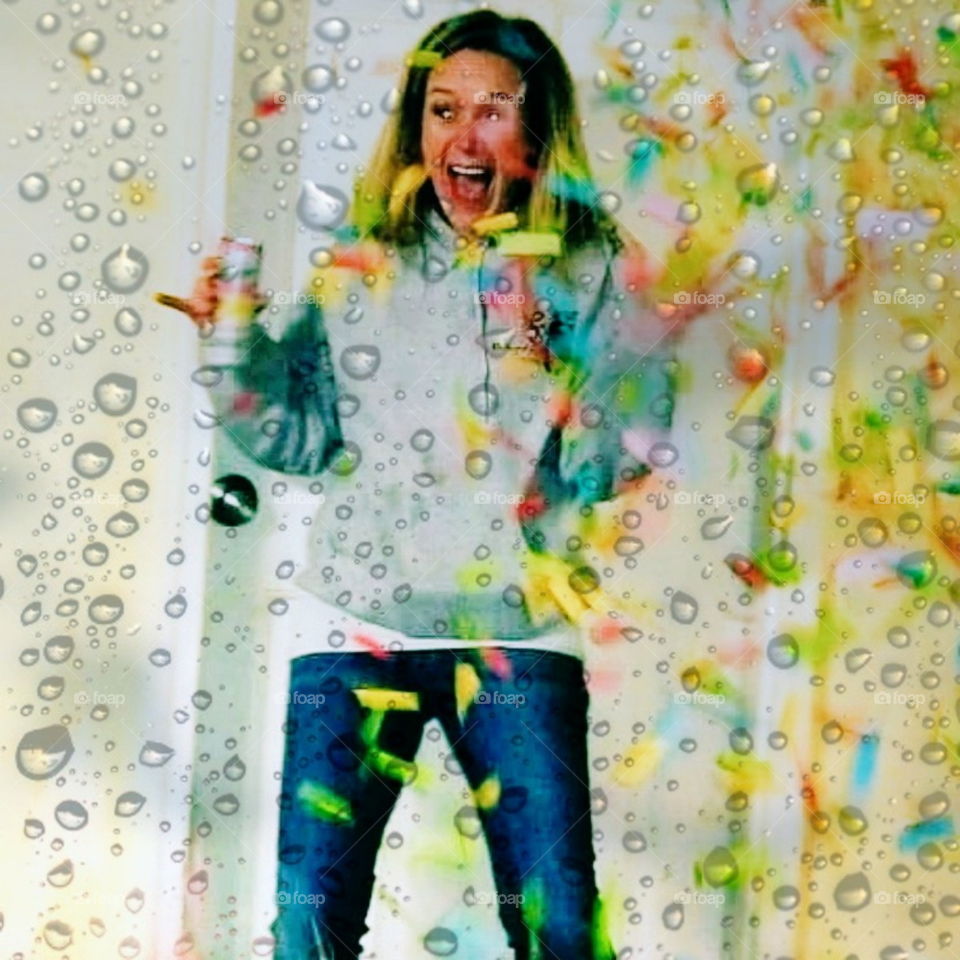 woman gets sprayed with confetti at a rainy winter birthday party and is beyond surprised.