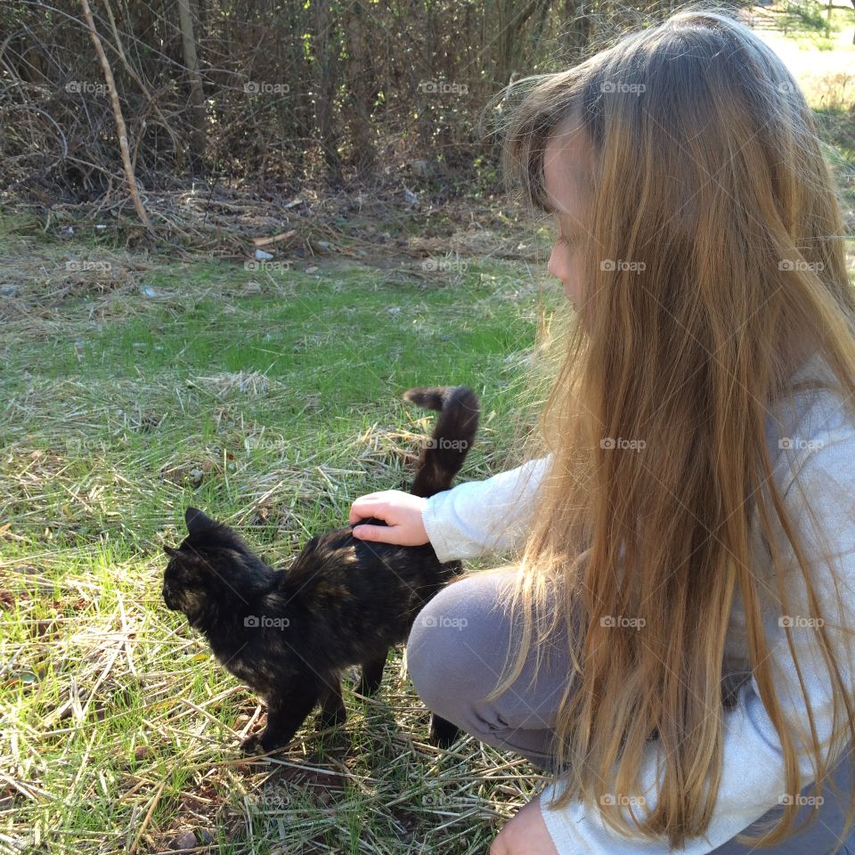 Girl petting kitten