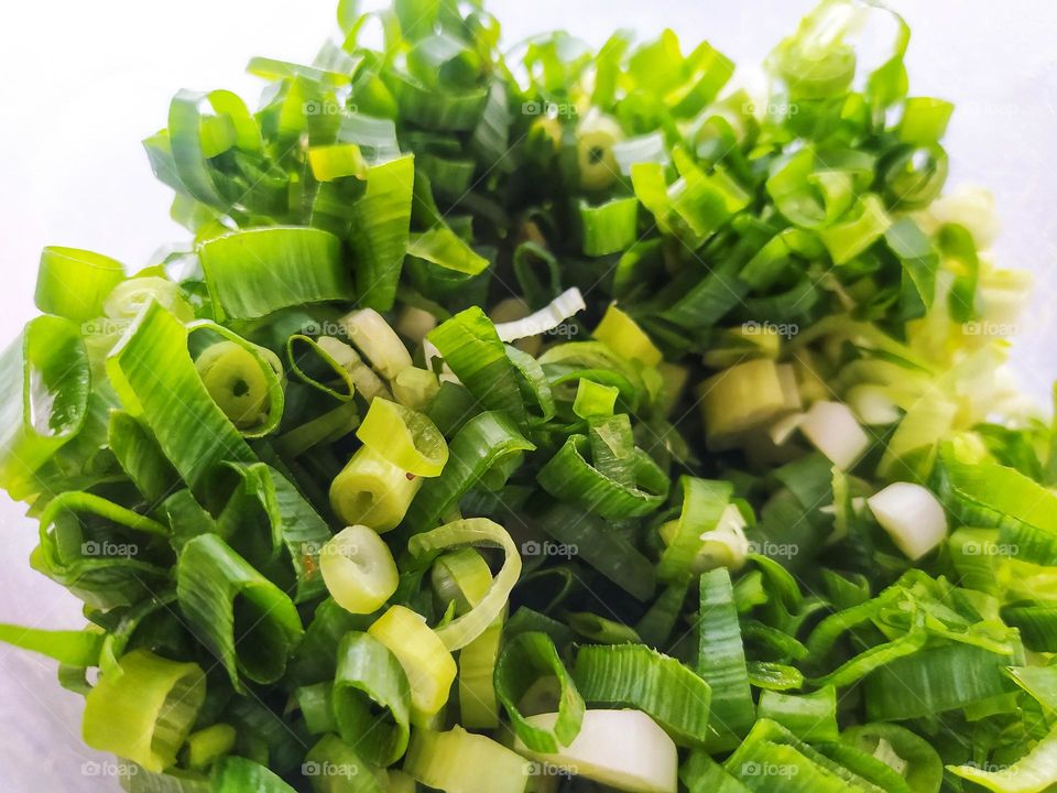 Sliced ​​scallions in a white container for noodle topping