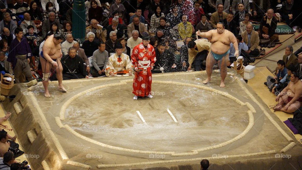 sumo wrestlers throw salt into the ring to purify it before each bout