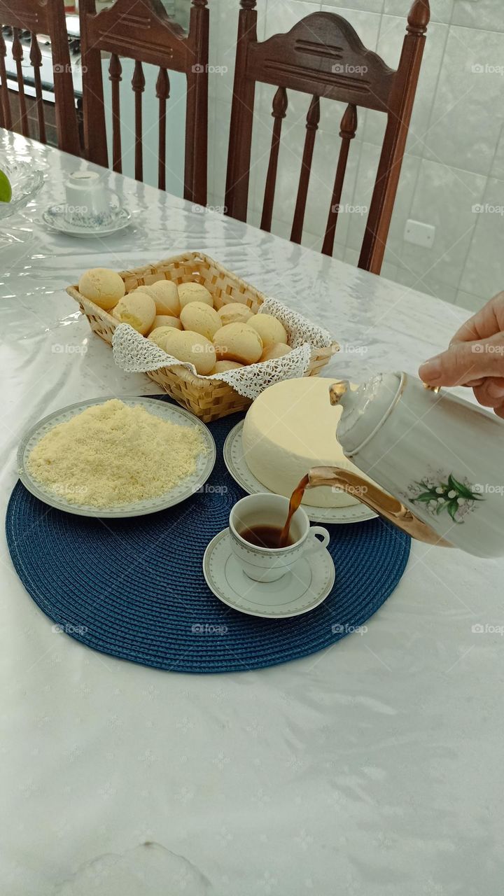 Traditional Mineiro Afternoon Coffee. Cheese bread, grated cheese, cured cheese and black coffee.