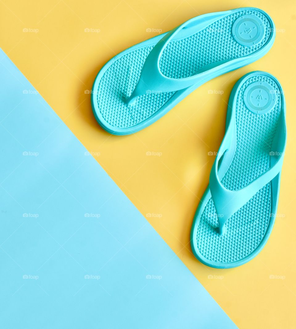 Flip flops on two color flat lay still life 