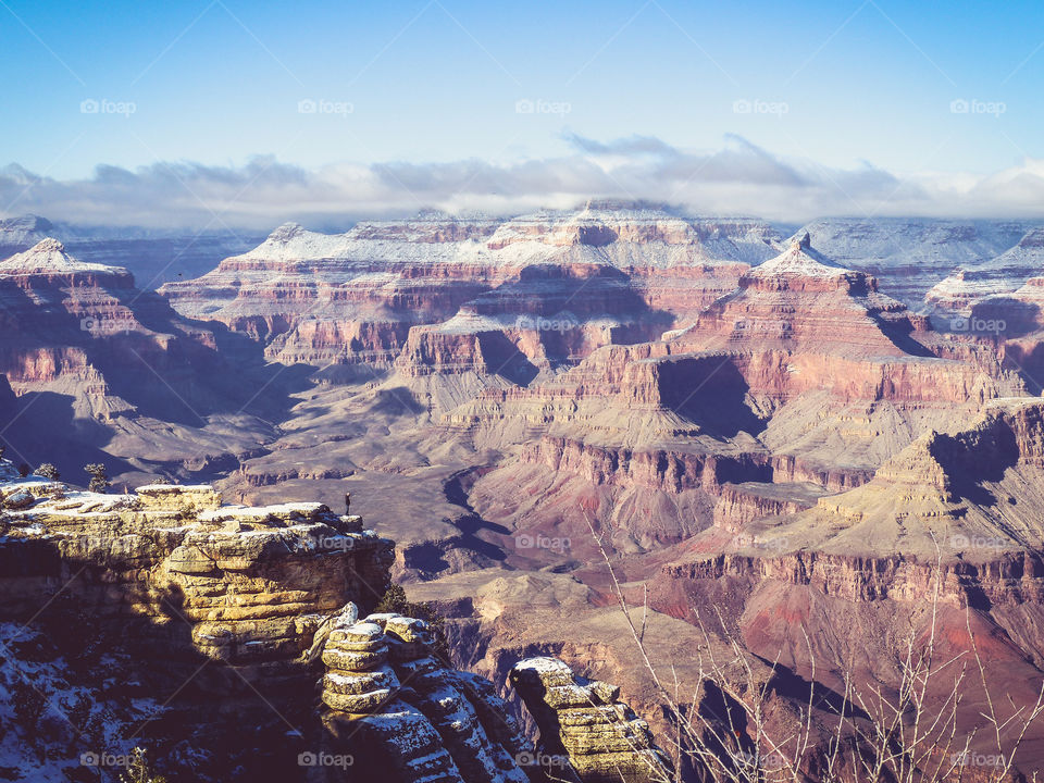 A man viewing the Grand Canyon from  the top.