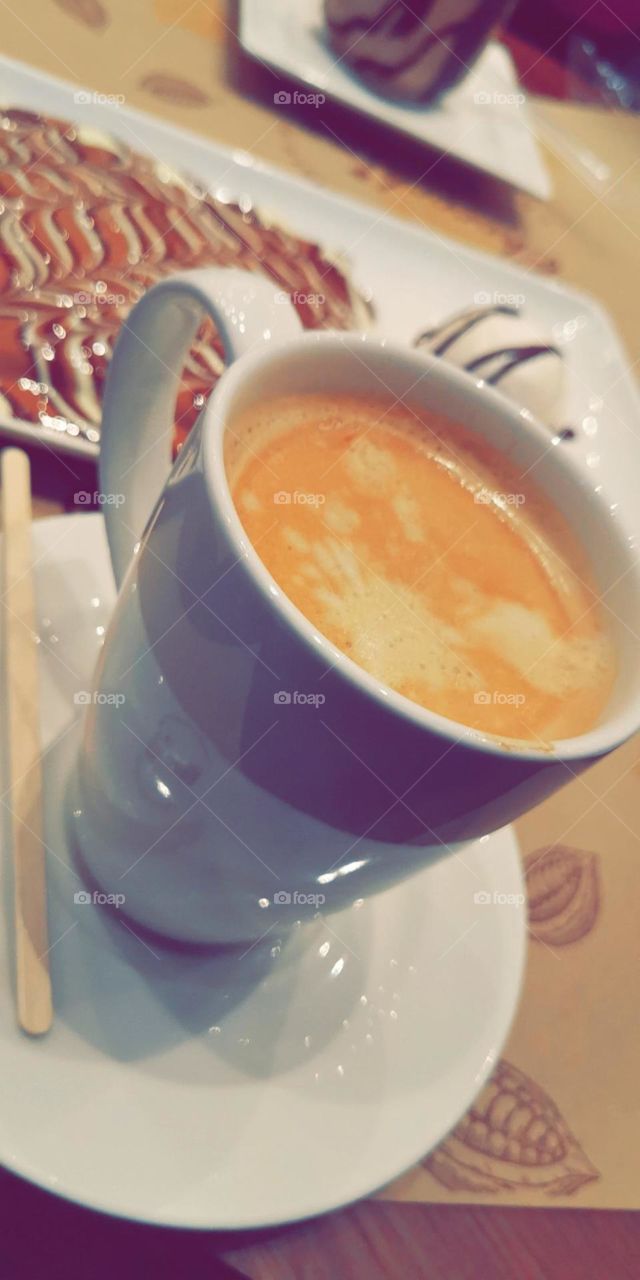 Hot cappuccino with waffle topped with chocolate