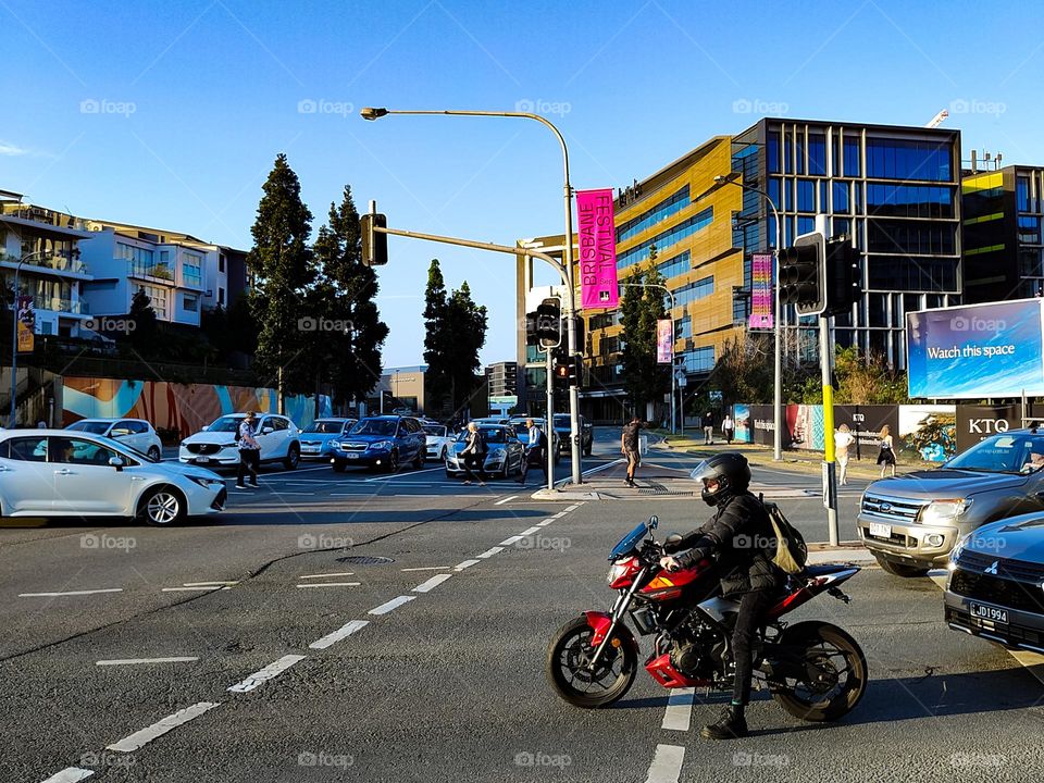 Motorcycle driver waiting for his turn in traffic lights.