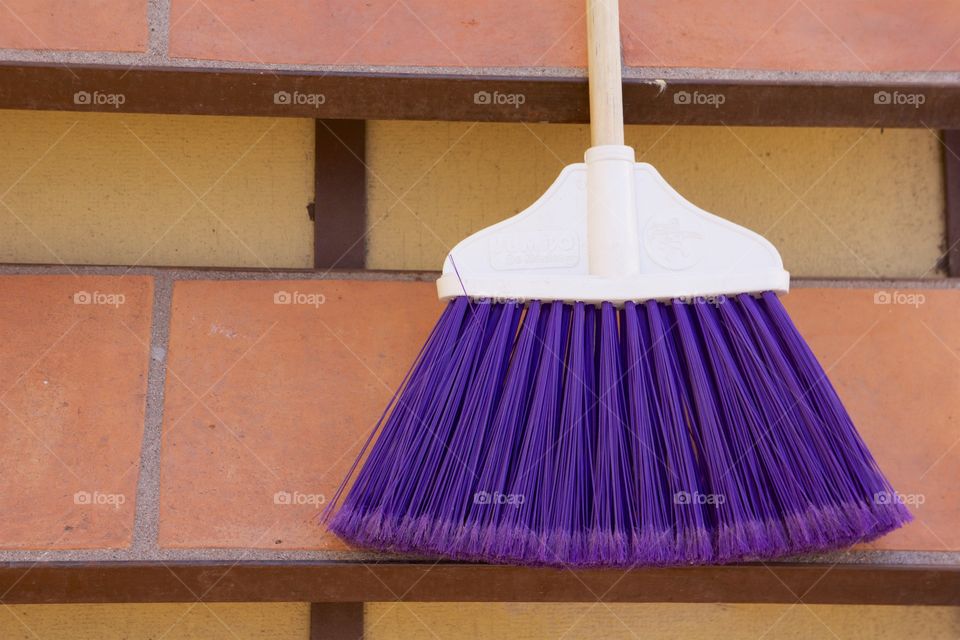 A purple broom stick placed on steps