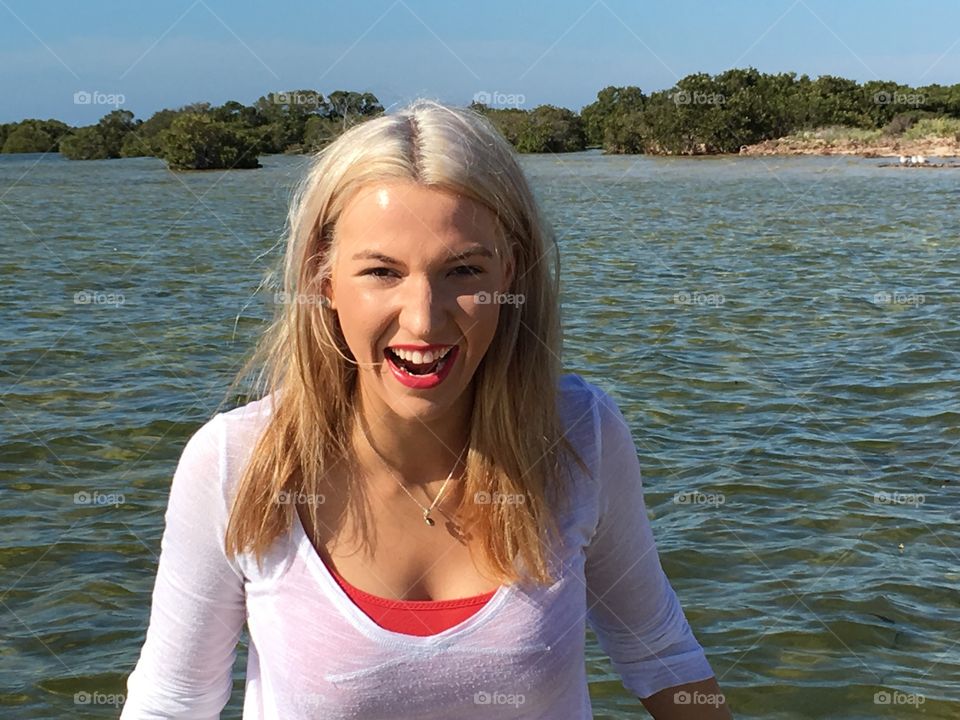 Smiling woman against lake