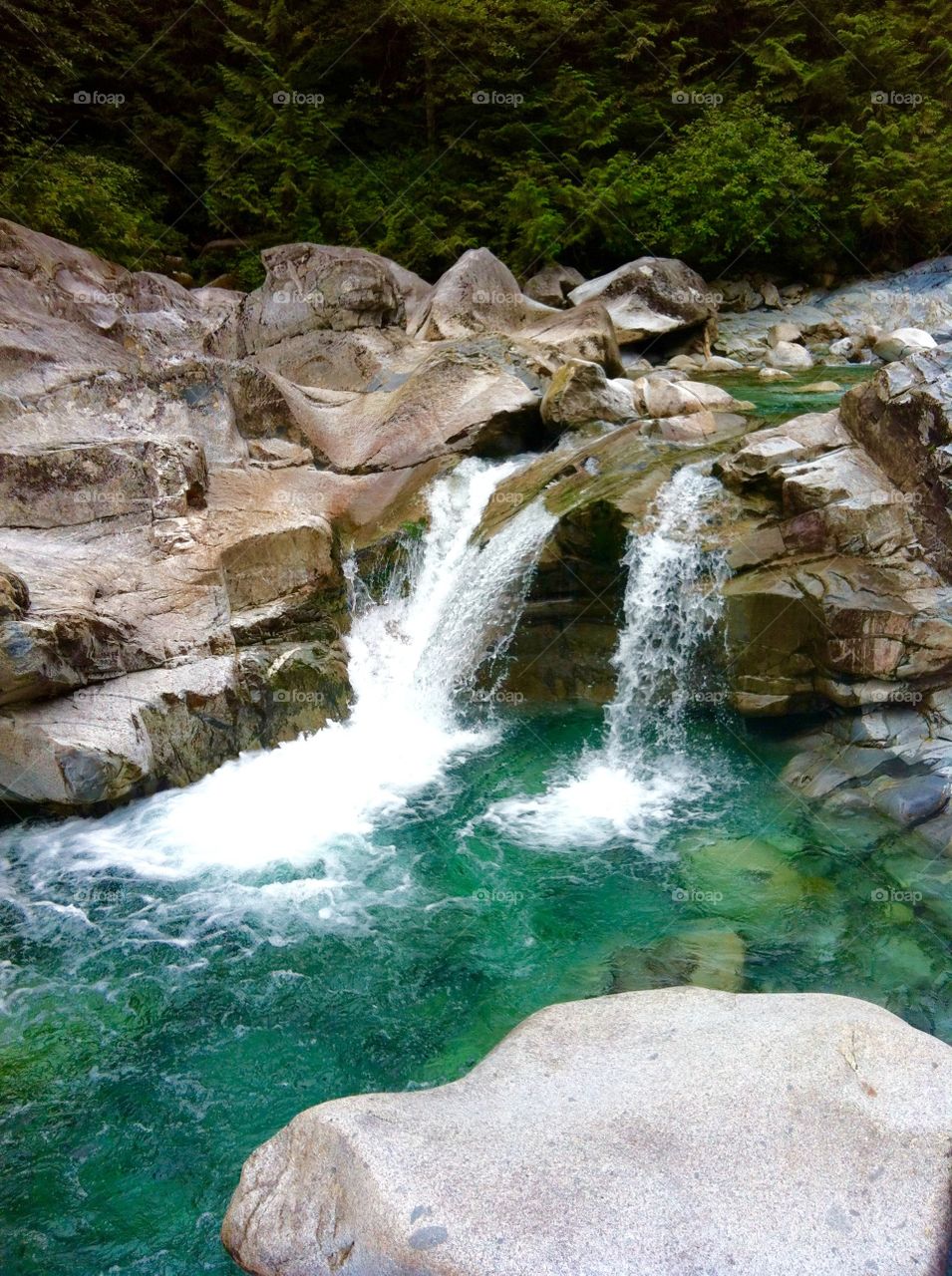 Beautiful waterfall with emerald green glacial waters