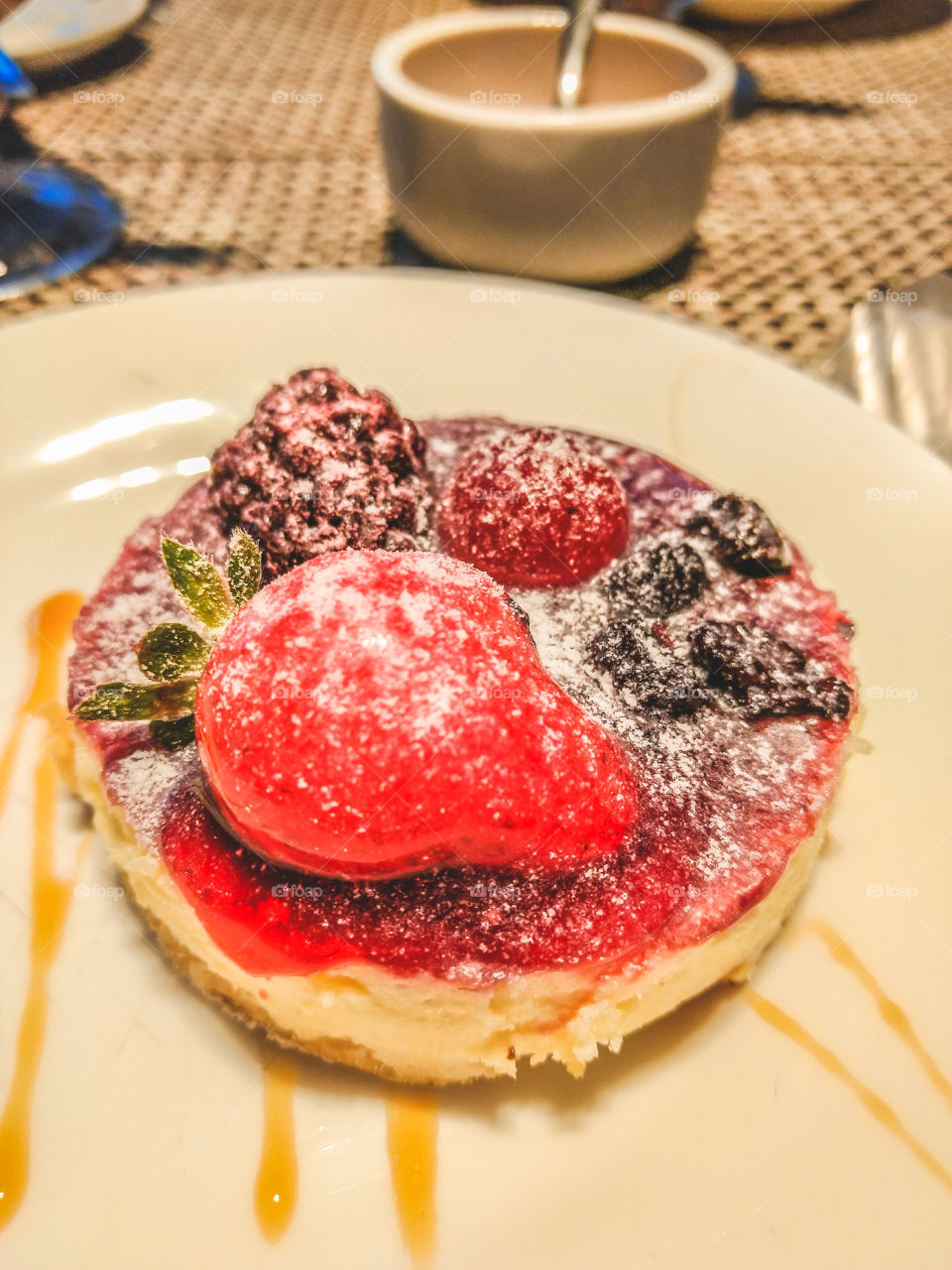 Delicious cheesecake covered by red fruits