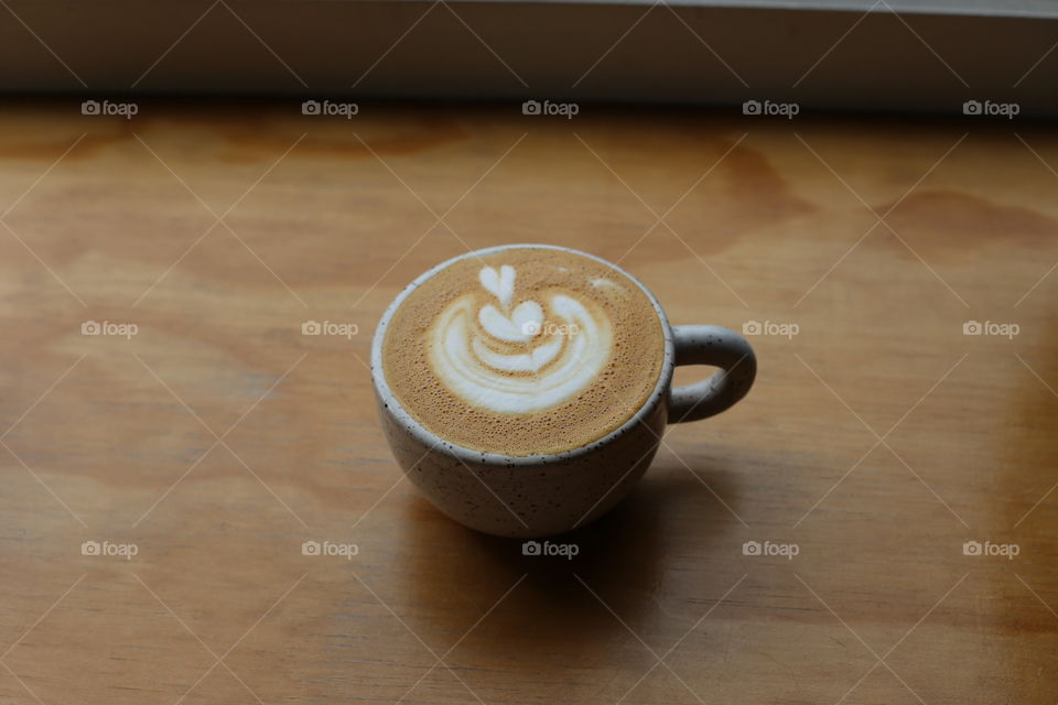 Cappuccino in soft window light.