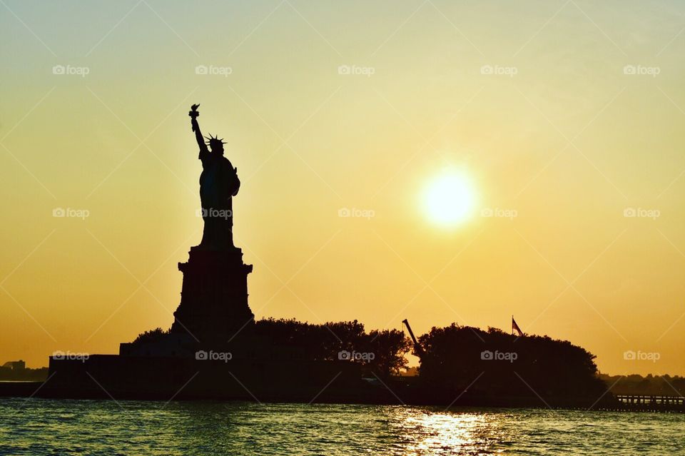 Statue of Liberty during sunset.  Sunset at Statue of Liberty.  Sunset cruise. 