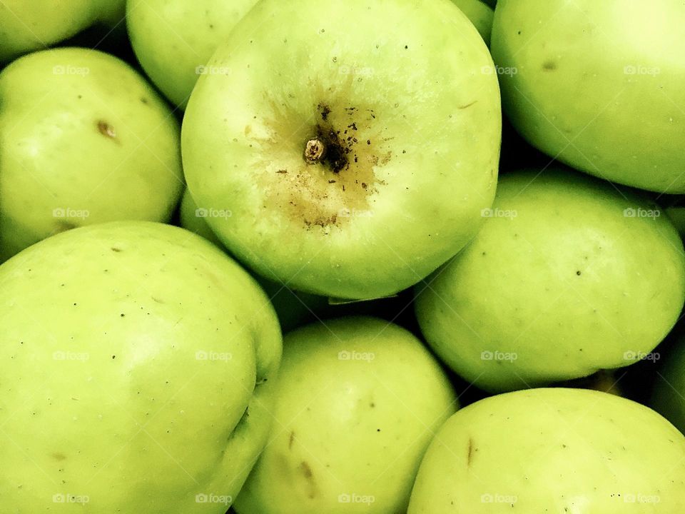 Fresh green apples directly from above texture background 