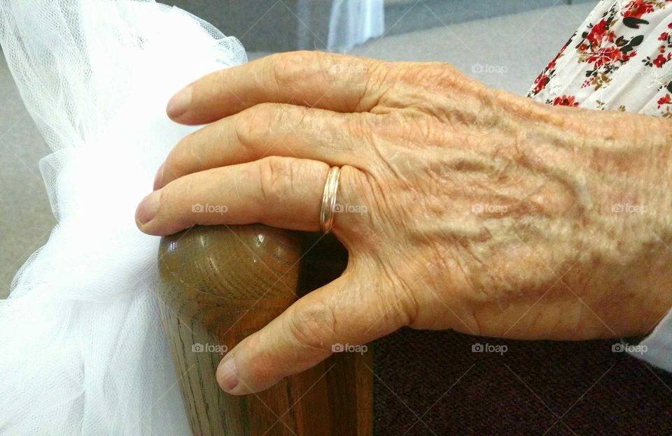 Man in his eighties with his arm around his wife of 65 years