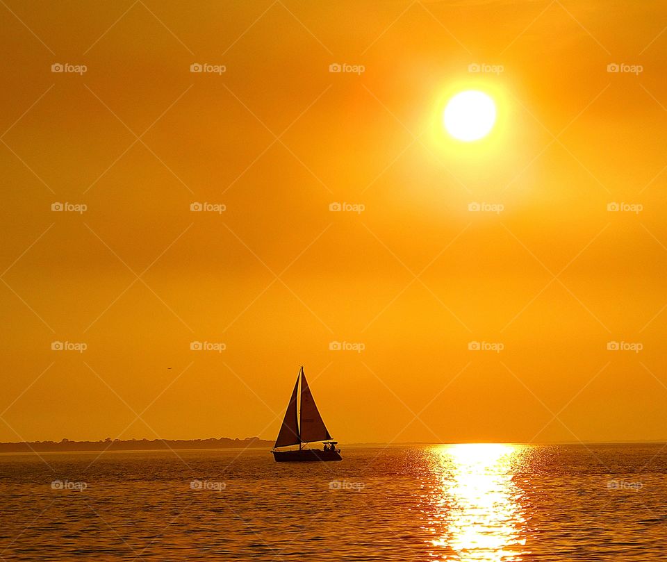 Impact of the sunset and sailboat