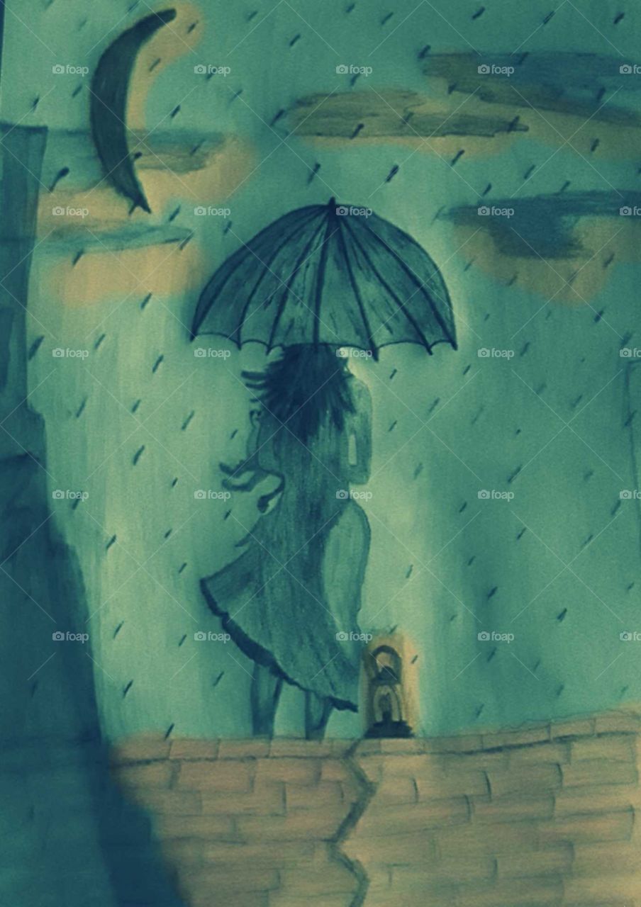 Girl holding kitten standing in the rain