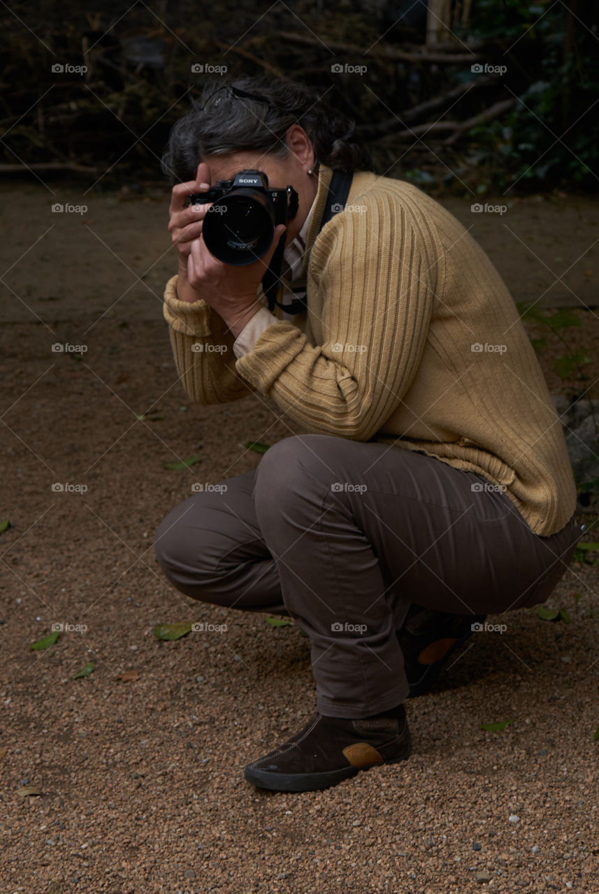 Close-up of a photographer clicking photograph