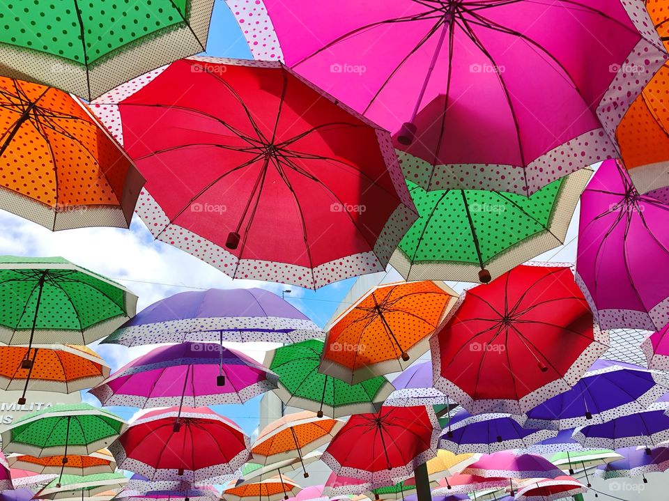 Colorful umbrellas on the blue sky