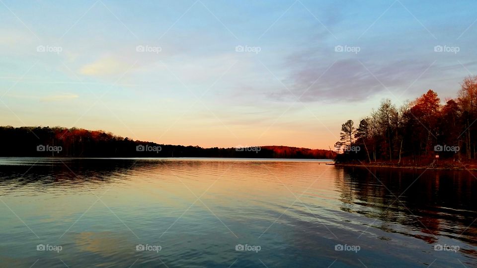 view of the lake at dawn during winter.