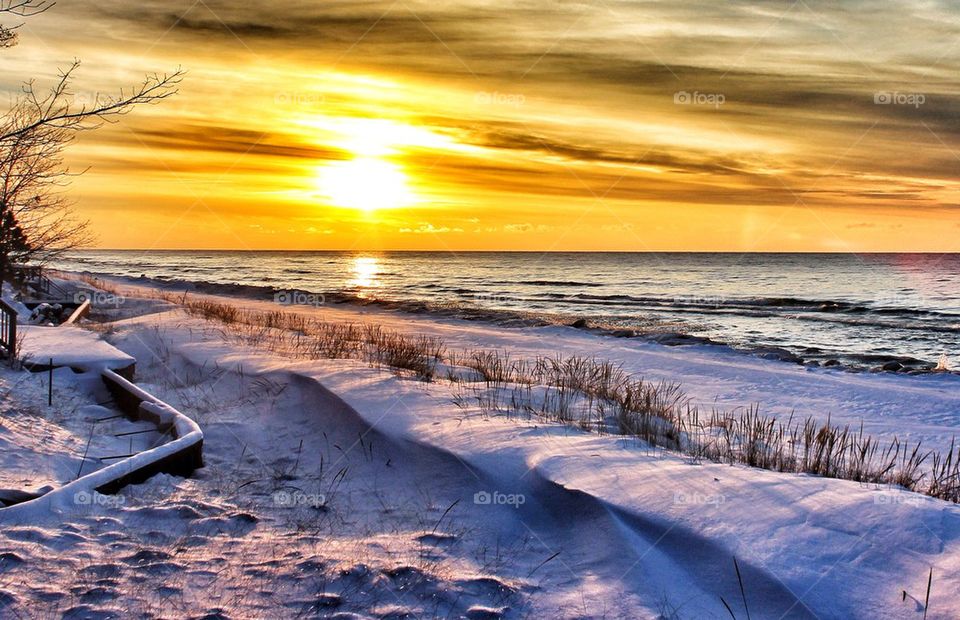 Sunset on a snow covered beach