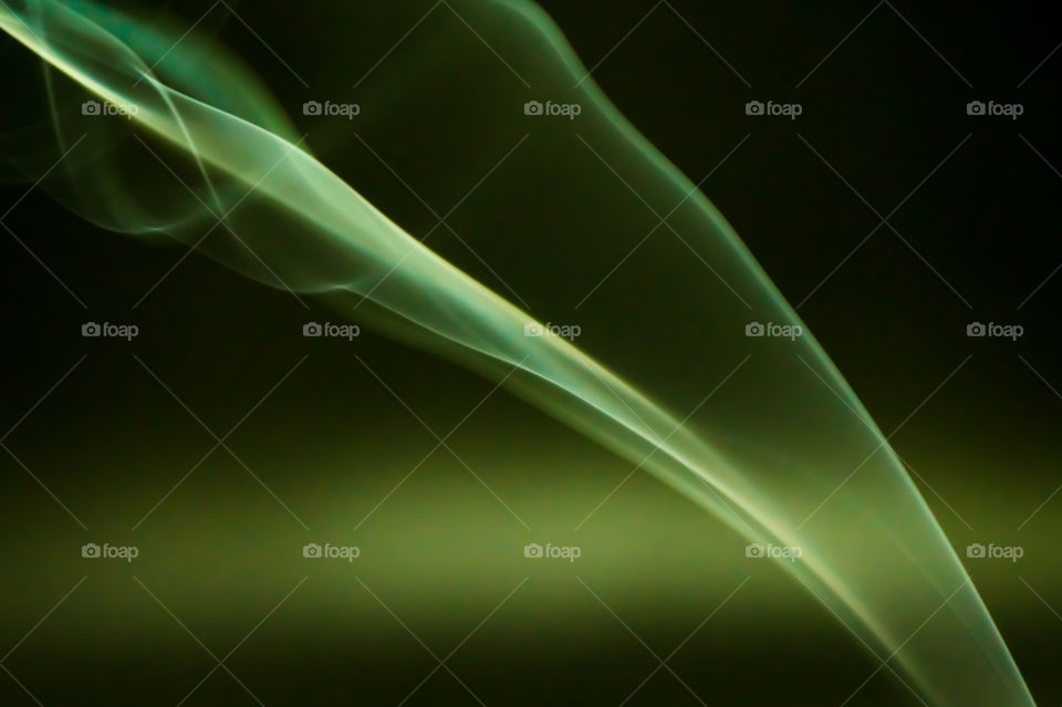 Smoke scented candles on black background