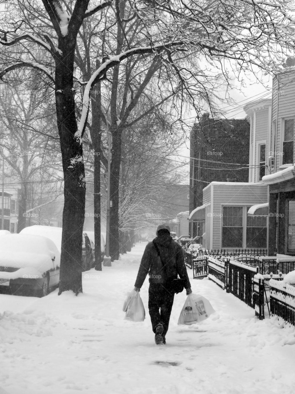 Man in snow with bags 