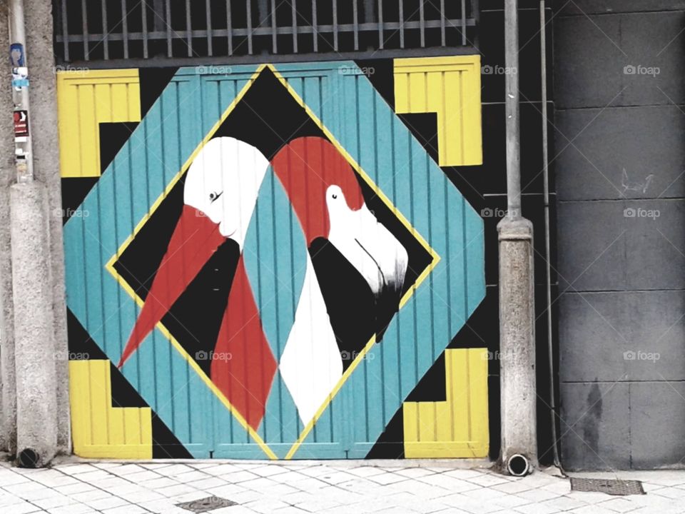 Mural of a flamingo and a crane. Geometric shapes. Street art.