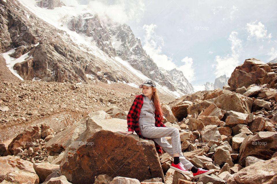 Teenage girl resting on a halt on a glacier in the mountains