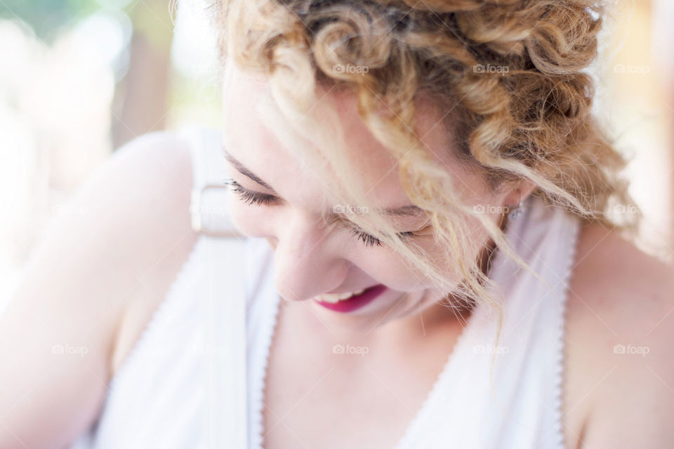 Laughter. Blond curly girl laughing closeup