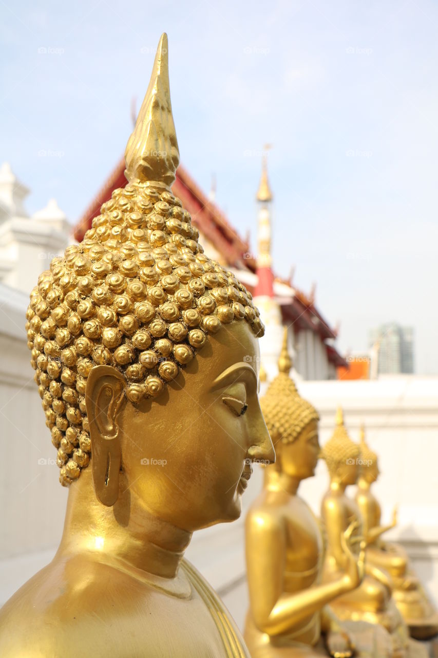 Golden Buddha statues​ located in Buddhism Temple.