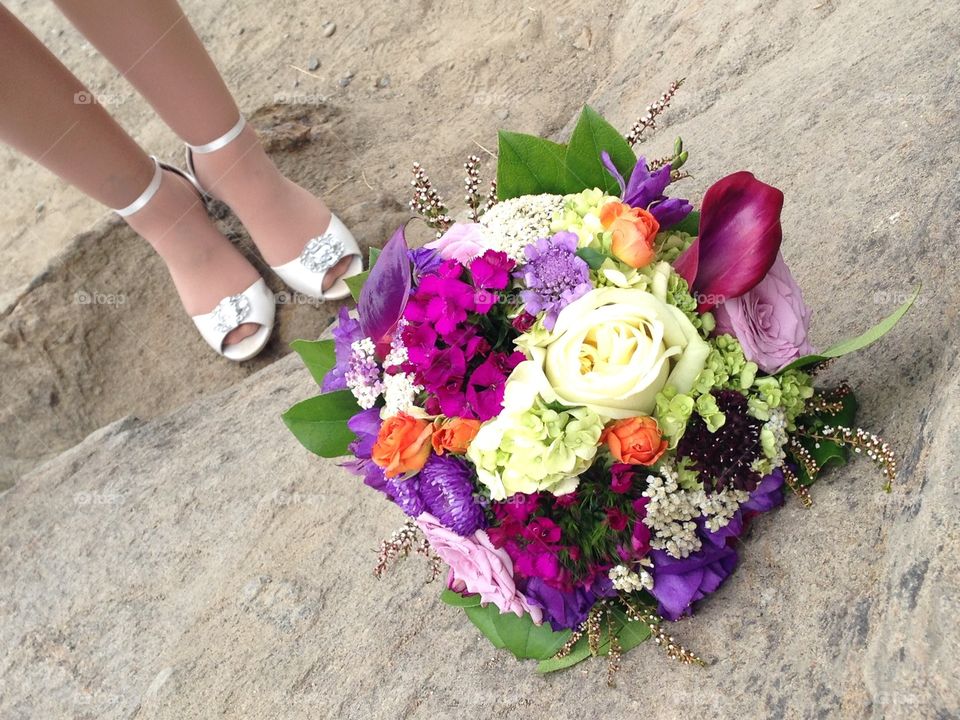 Wedding bouquet with bridal shoes in background