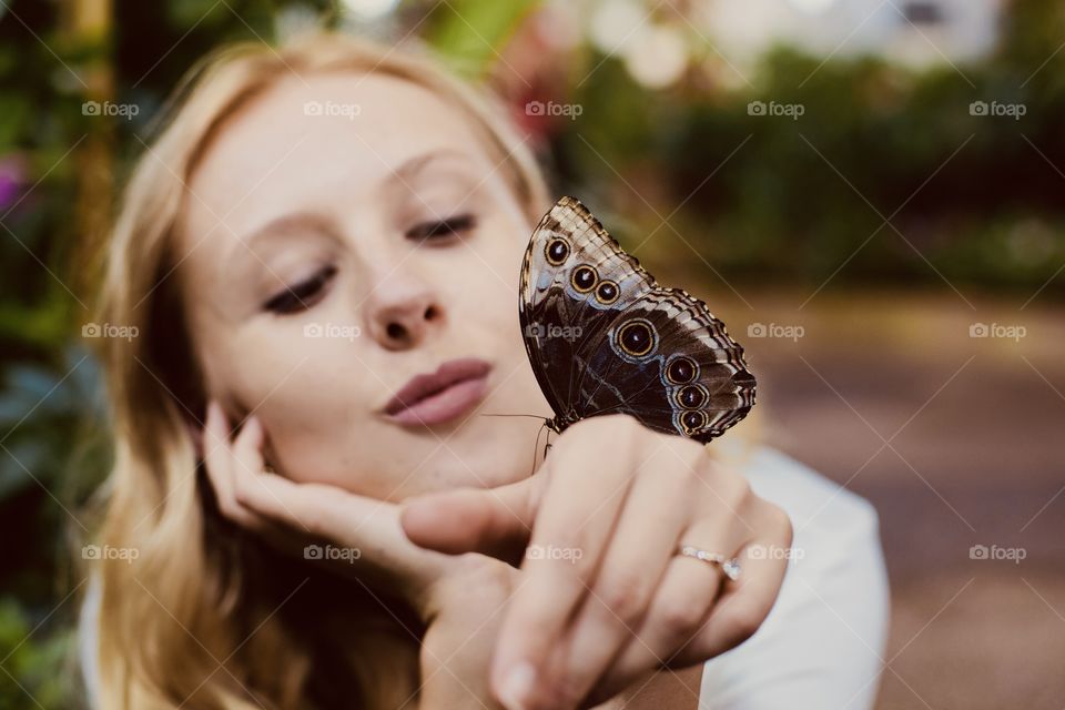 Girl hold and going to kiss brown butterfly 