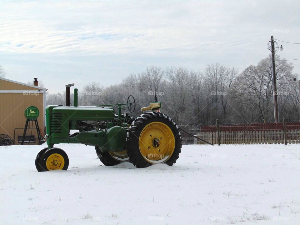 A tractor in the snow. 