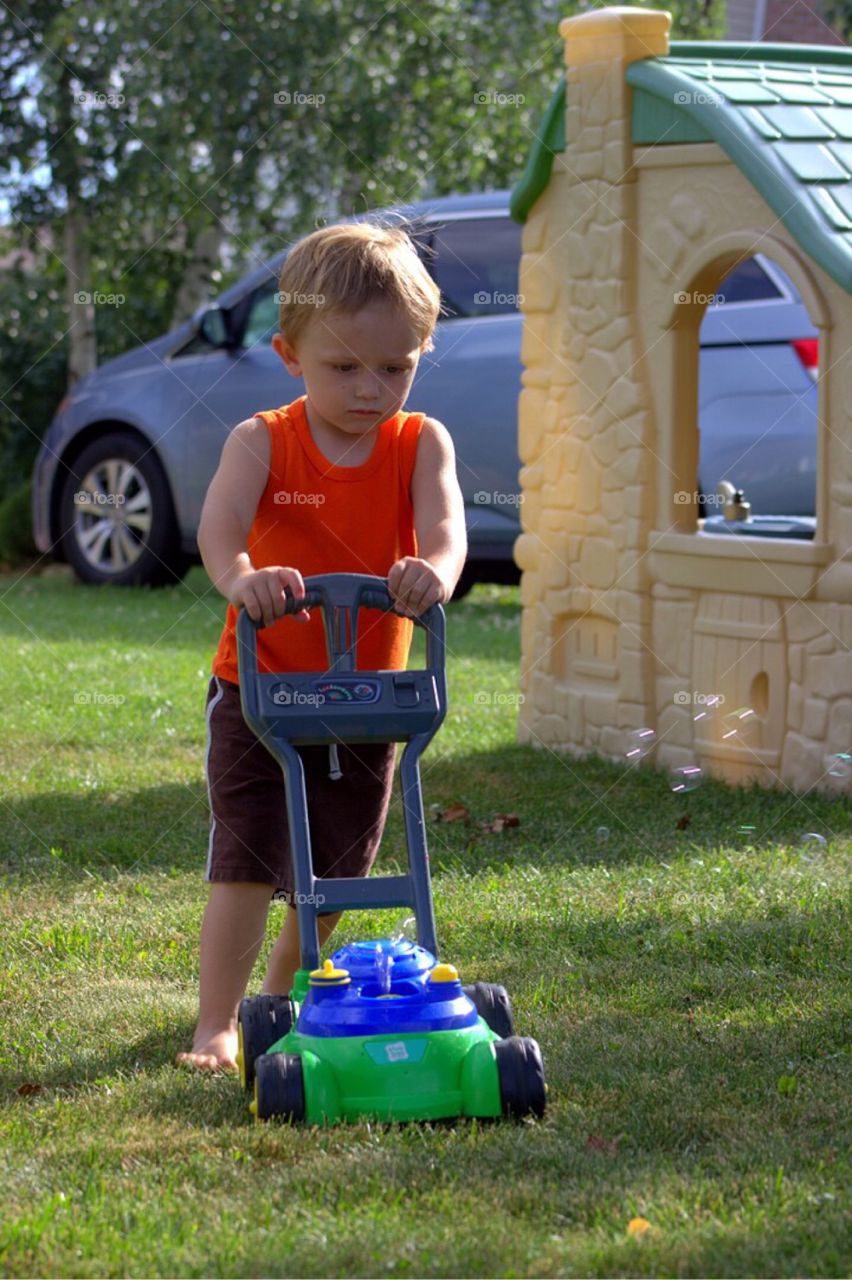 Boy mowing the lawn